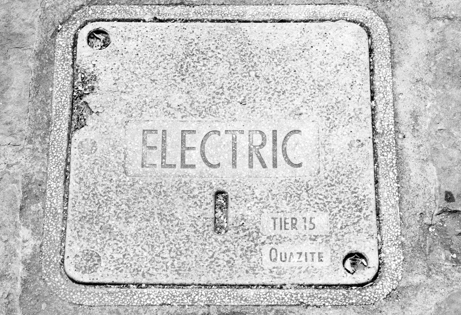 Metal electric utility cover with text.