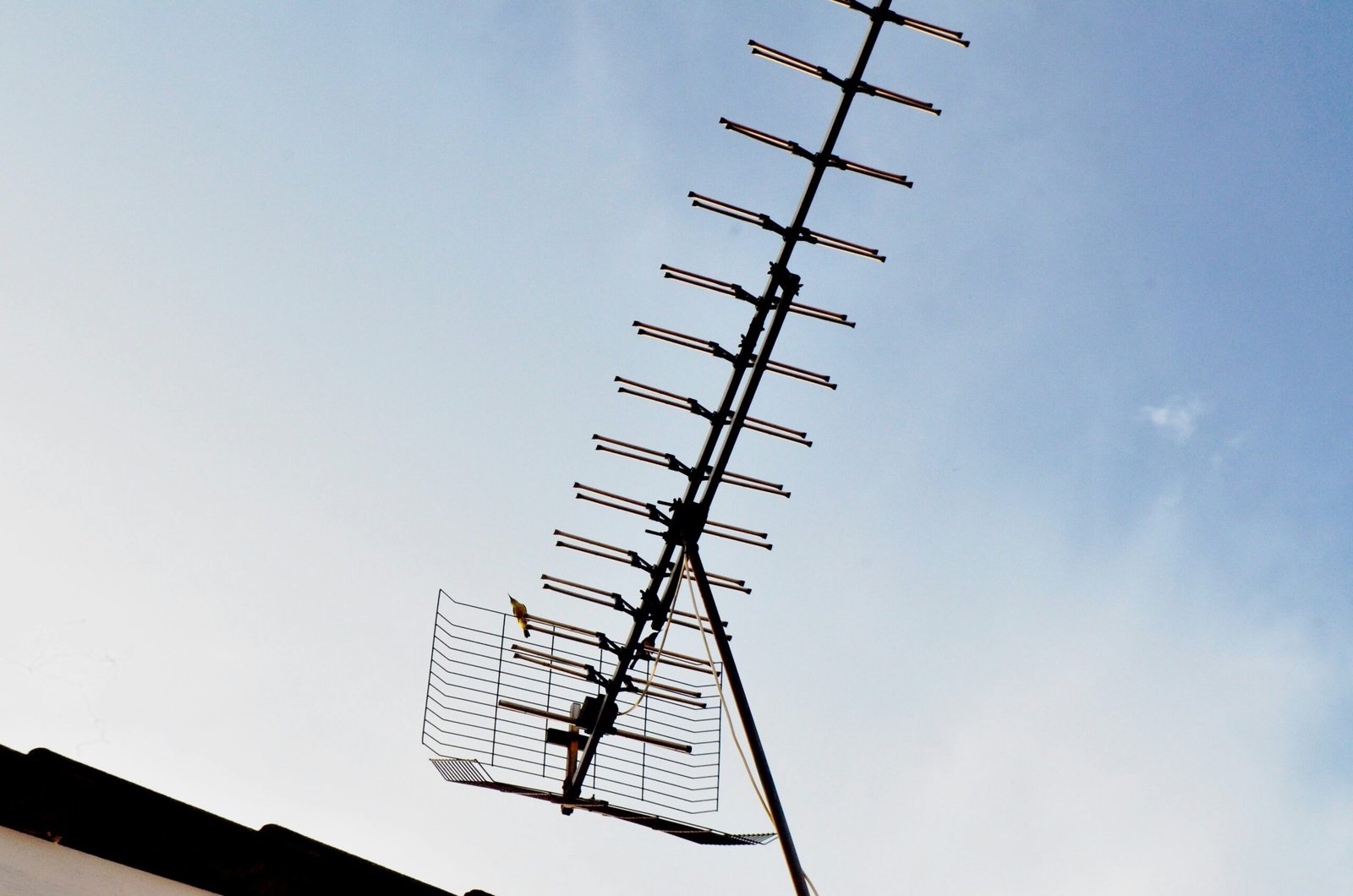 black metal electric post under gray sky