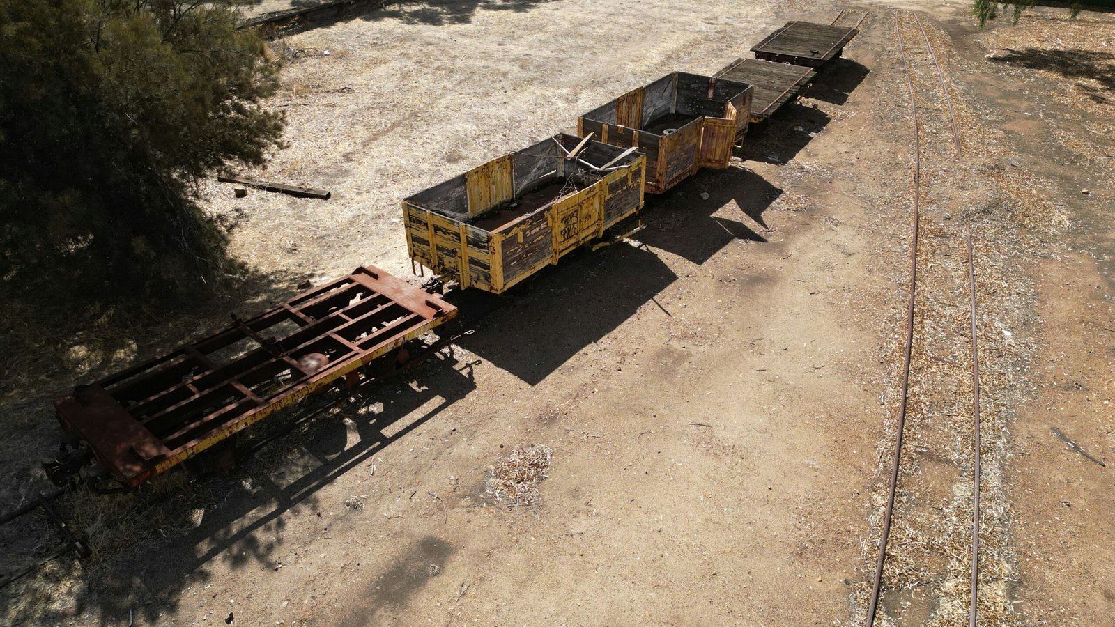 A derelict train sits on abandoned tracks.
