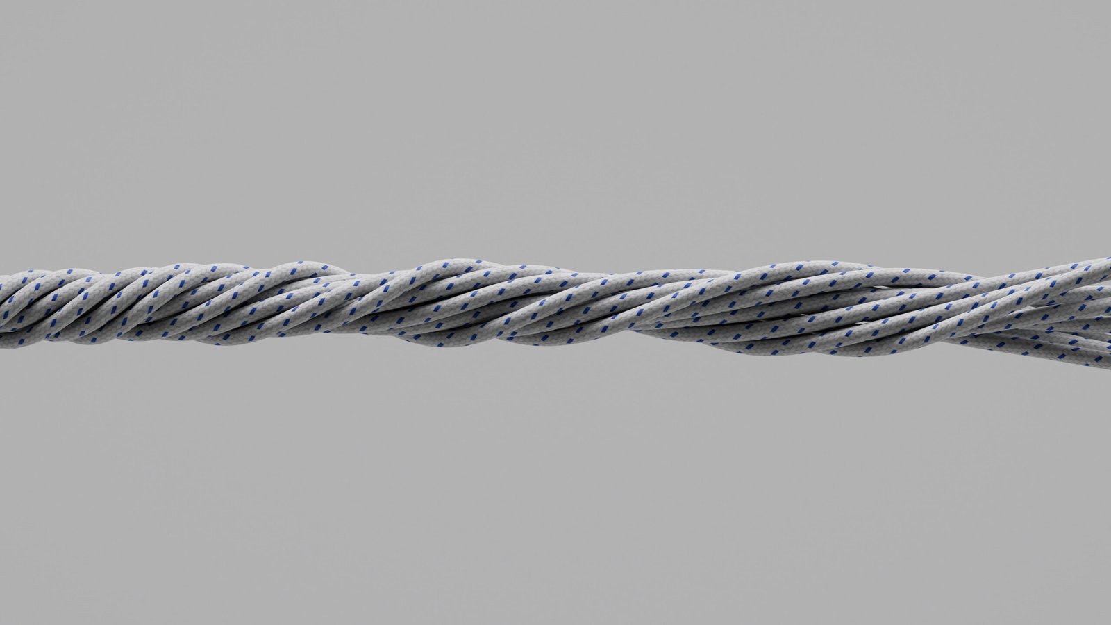 Close-up of twisted gray metal cable on gray background
