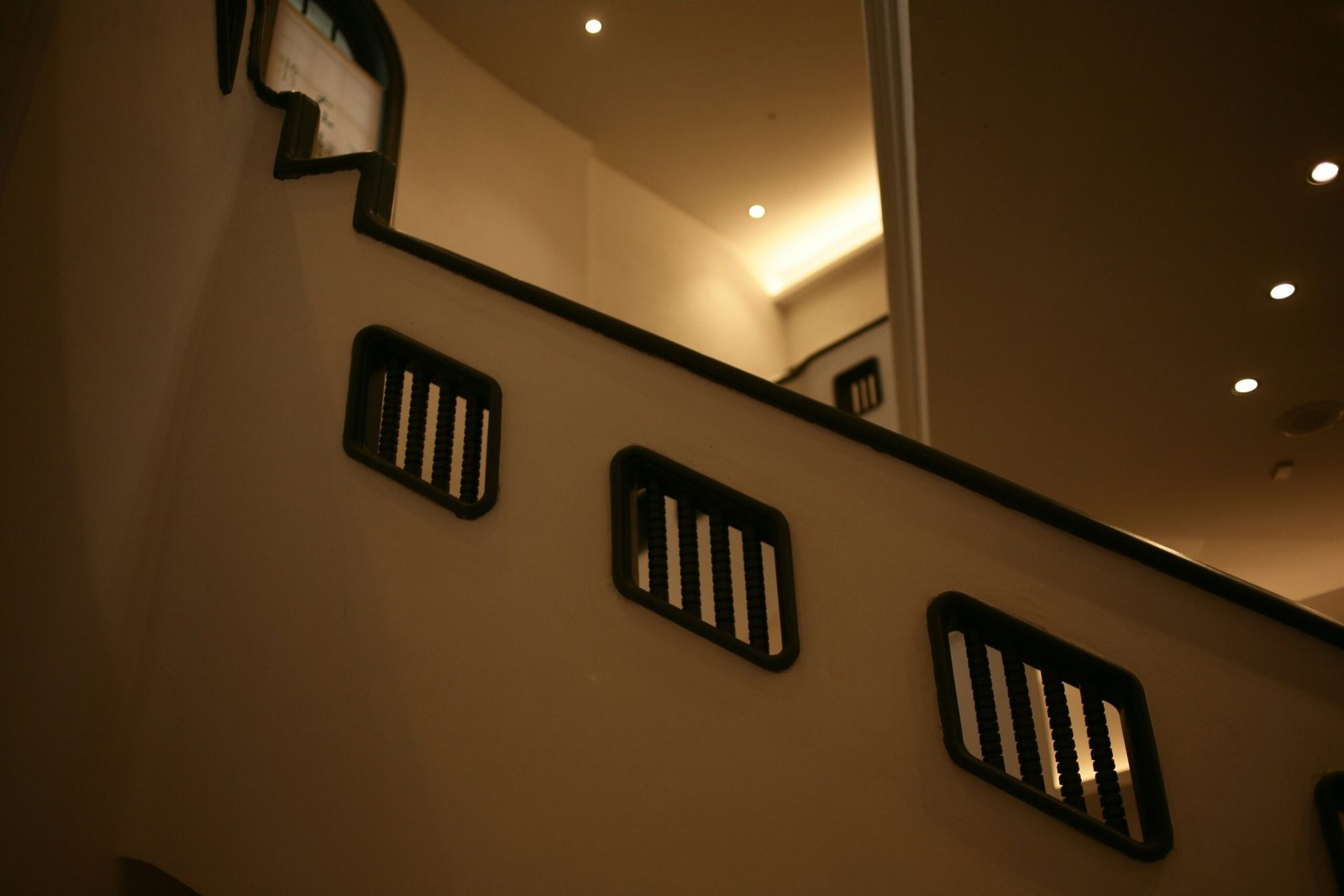 a mirror on the wall above a stair case