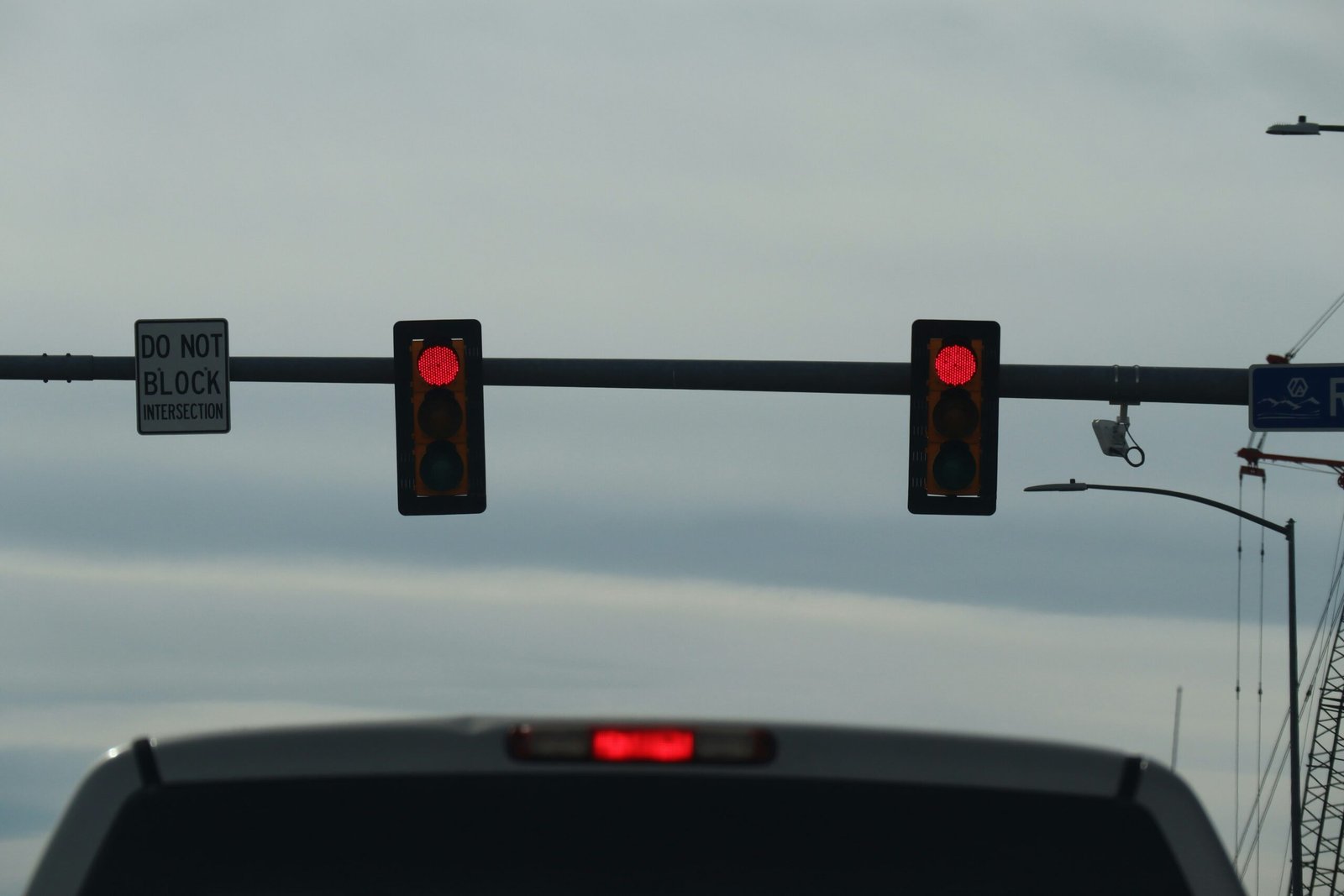 a couple of traffic lights hanging from a metal pole