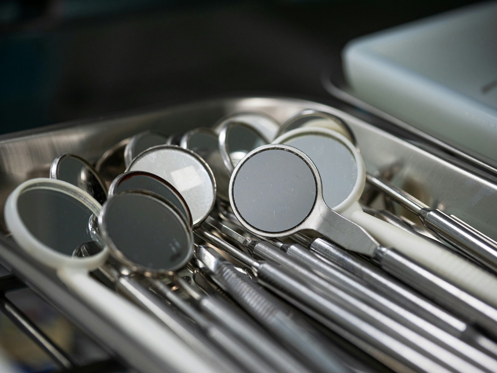 Dental mirrors and tools arranged on a tray.