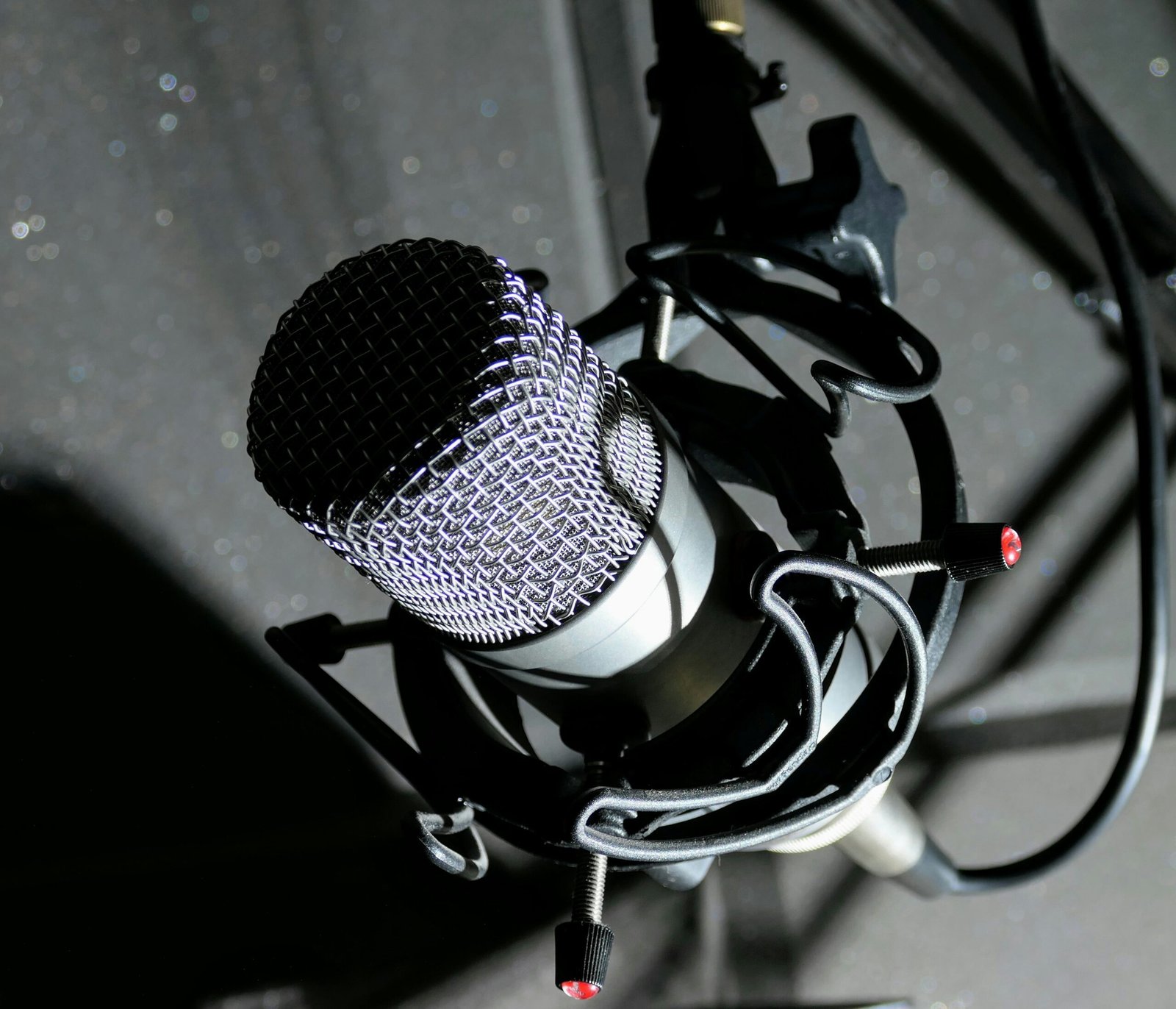 black and gray microphone on black and white textile