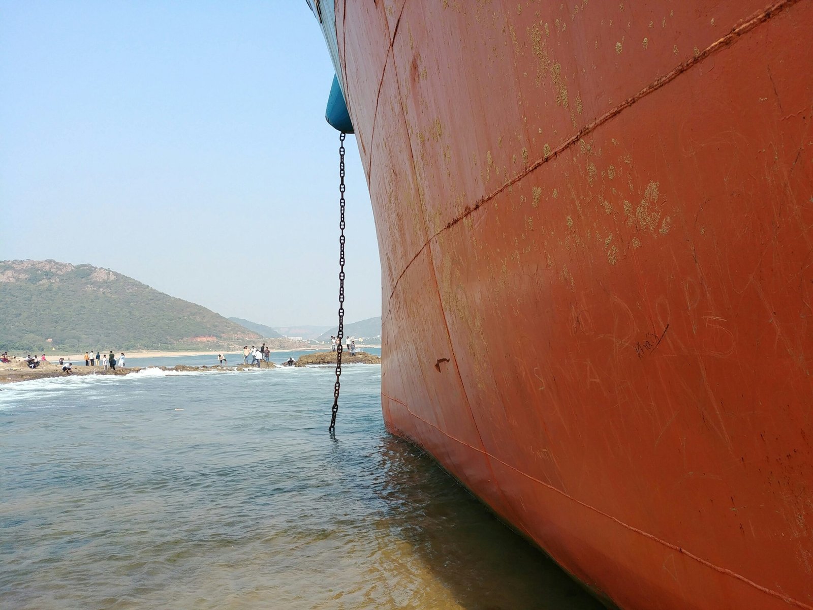 a large red boat sitting on top of a body of water