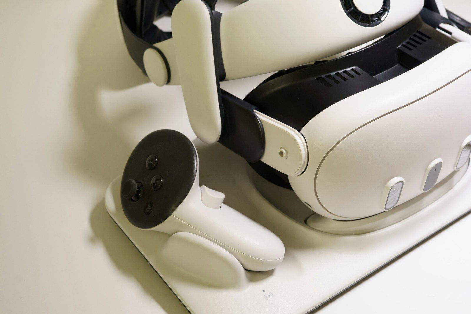 White virtual reality headset and controller on table