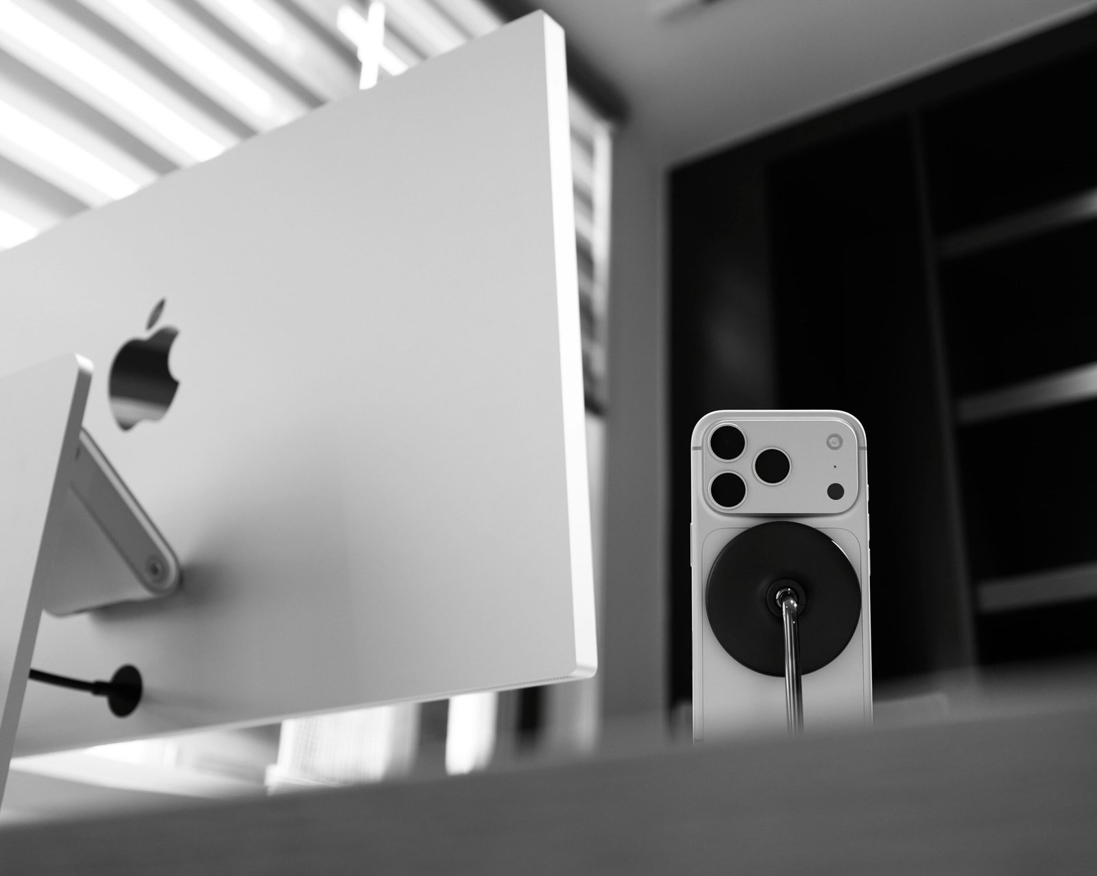 Apple computer monitor with iPhone and charger