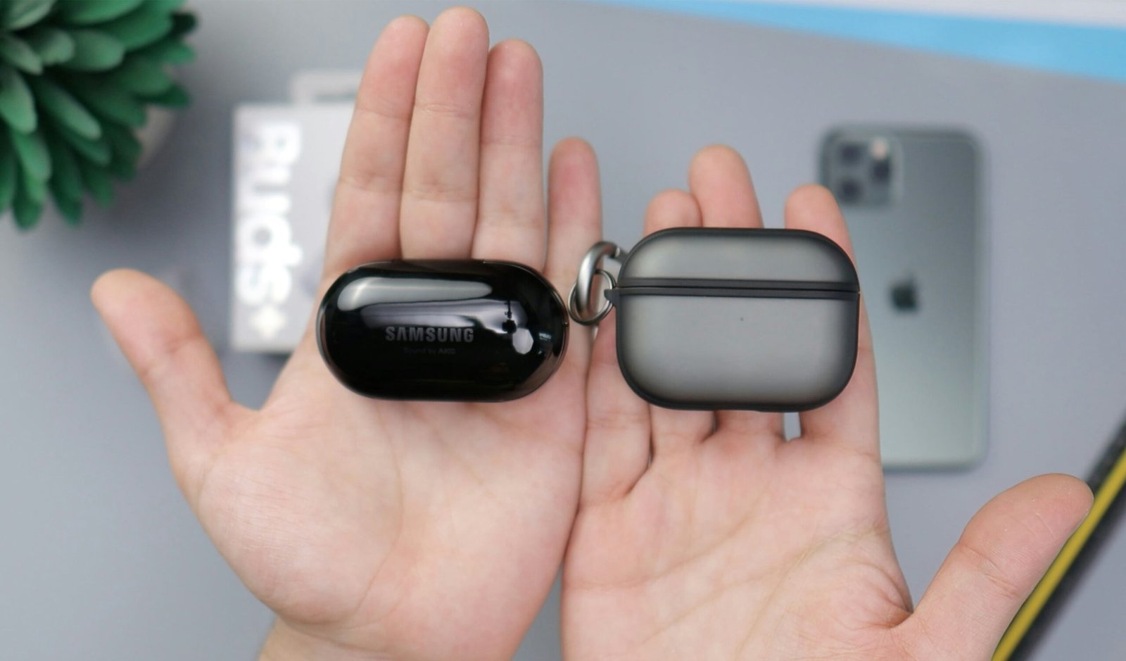 black samsung bluetooth earbuds on persons hand