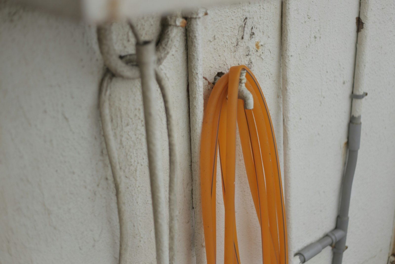 A bunch of orange cords hanging on a wall