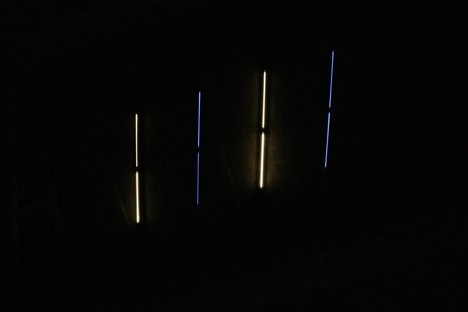 a dark room with three lights in the dark