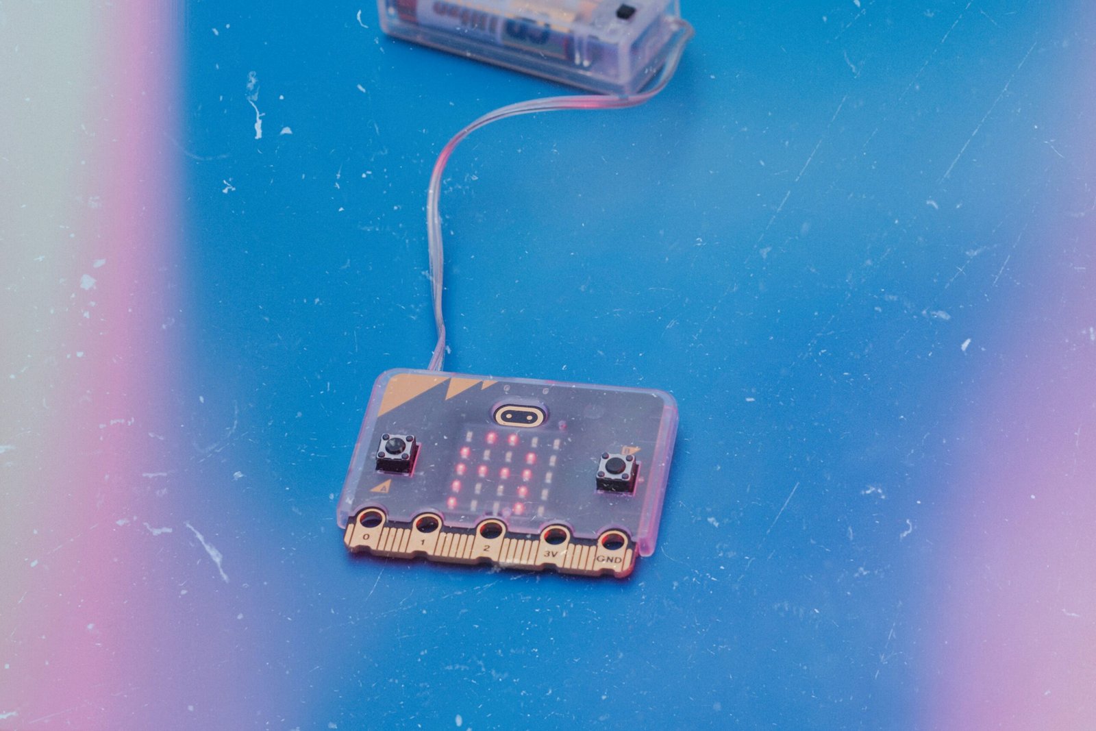 Two micro:bit electronic boards connected by wire
