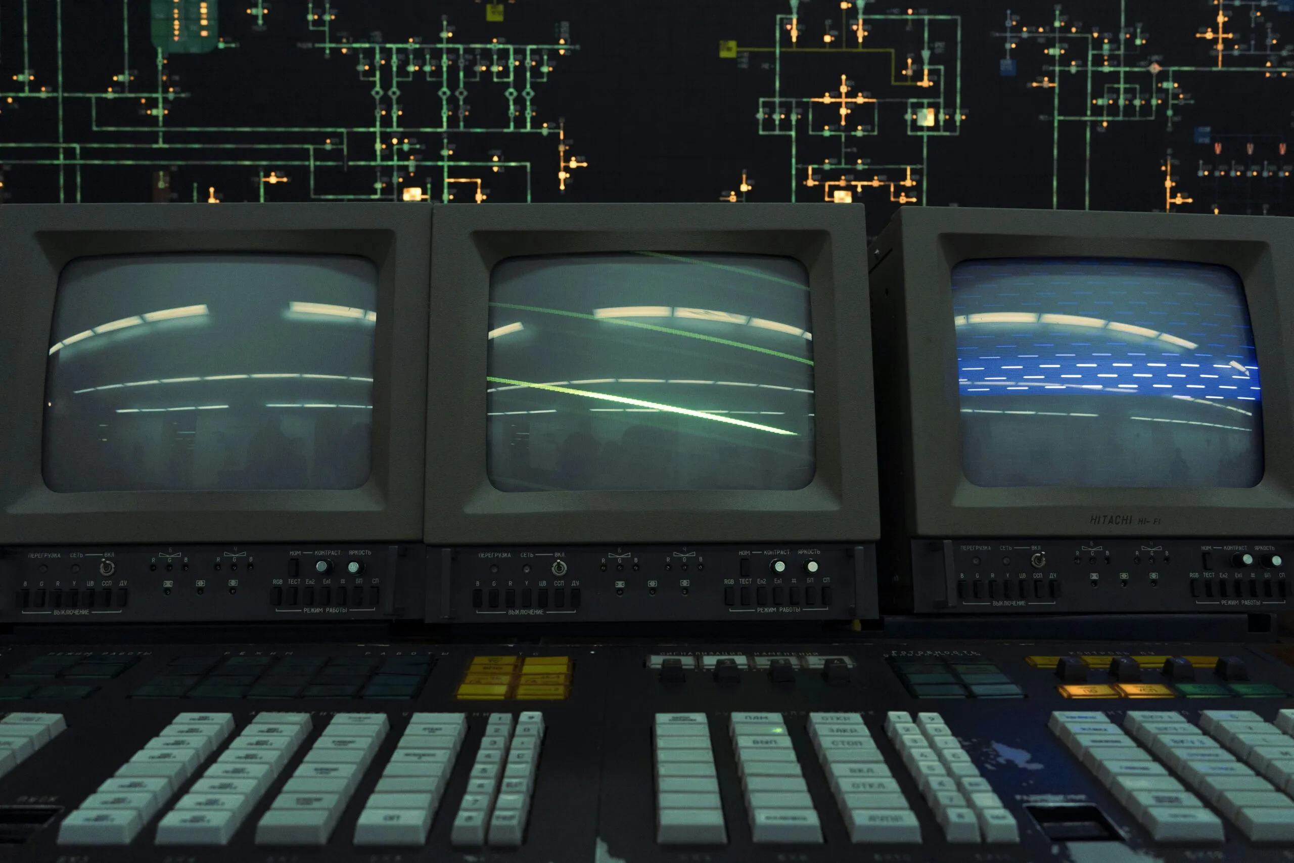 Three old crt monitors display a line.