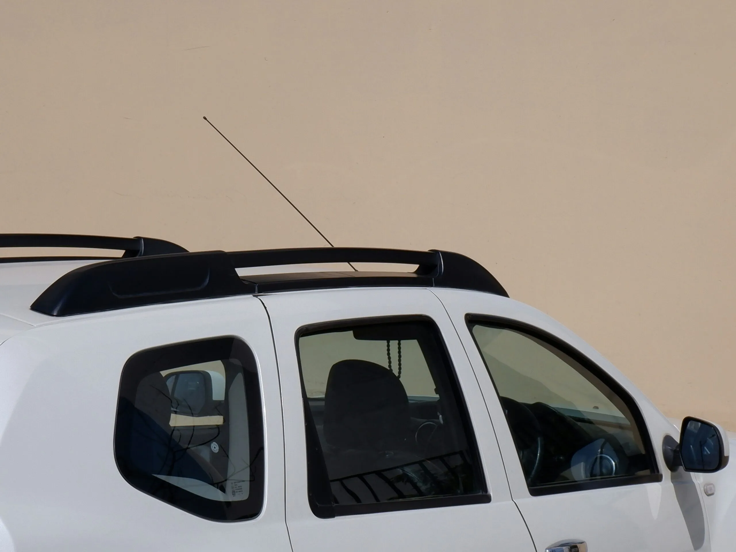 a white car with a black roof rack