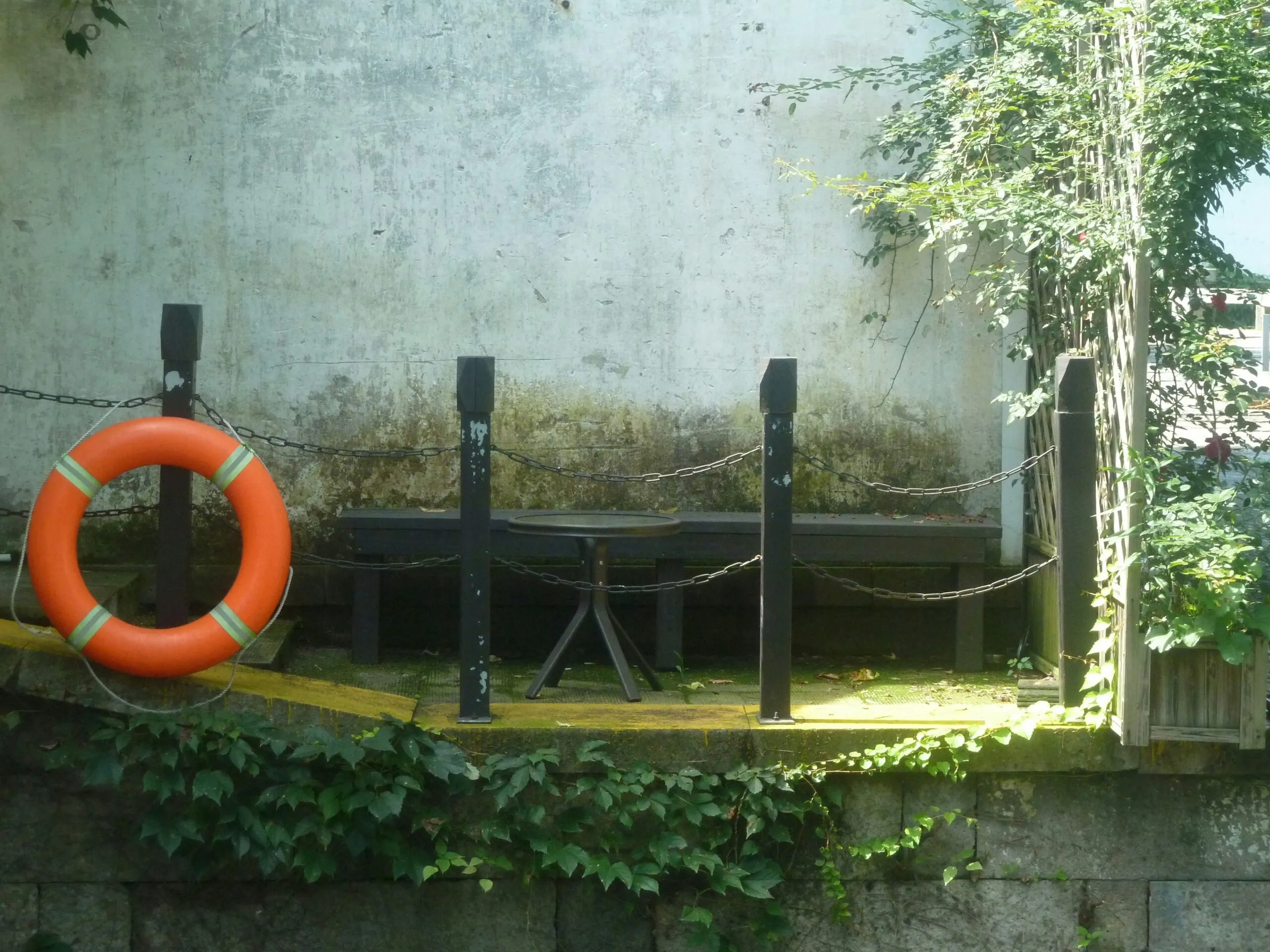 A life ring hangs beside a wooden dock.