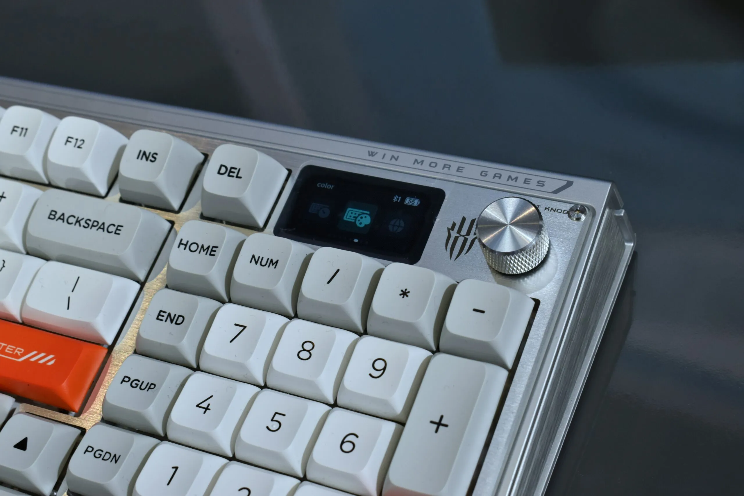 Close-up of a modern mechanical keyboard with display.