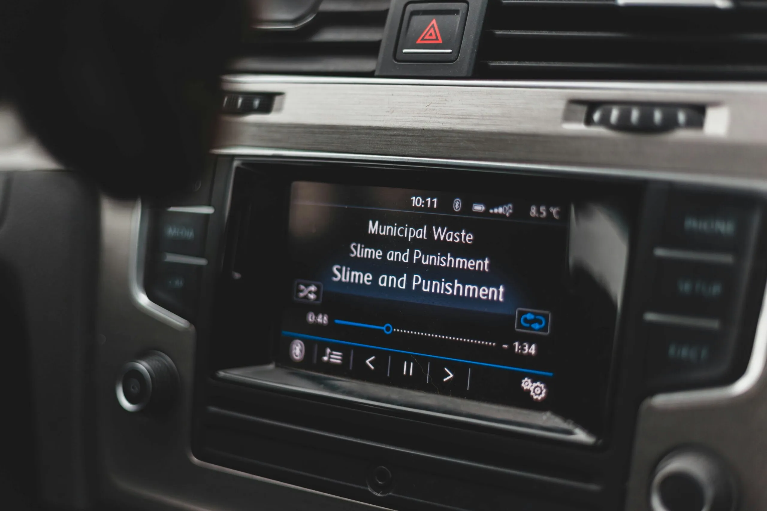 a car dashboard with a radio and a remote control