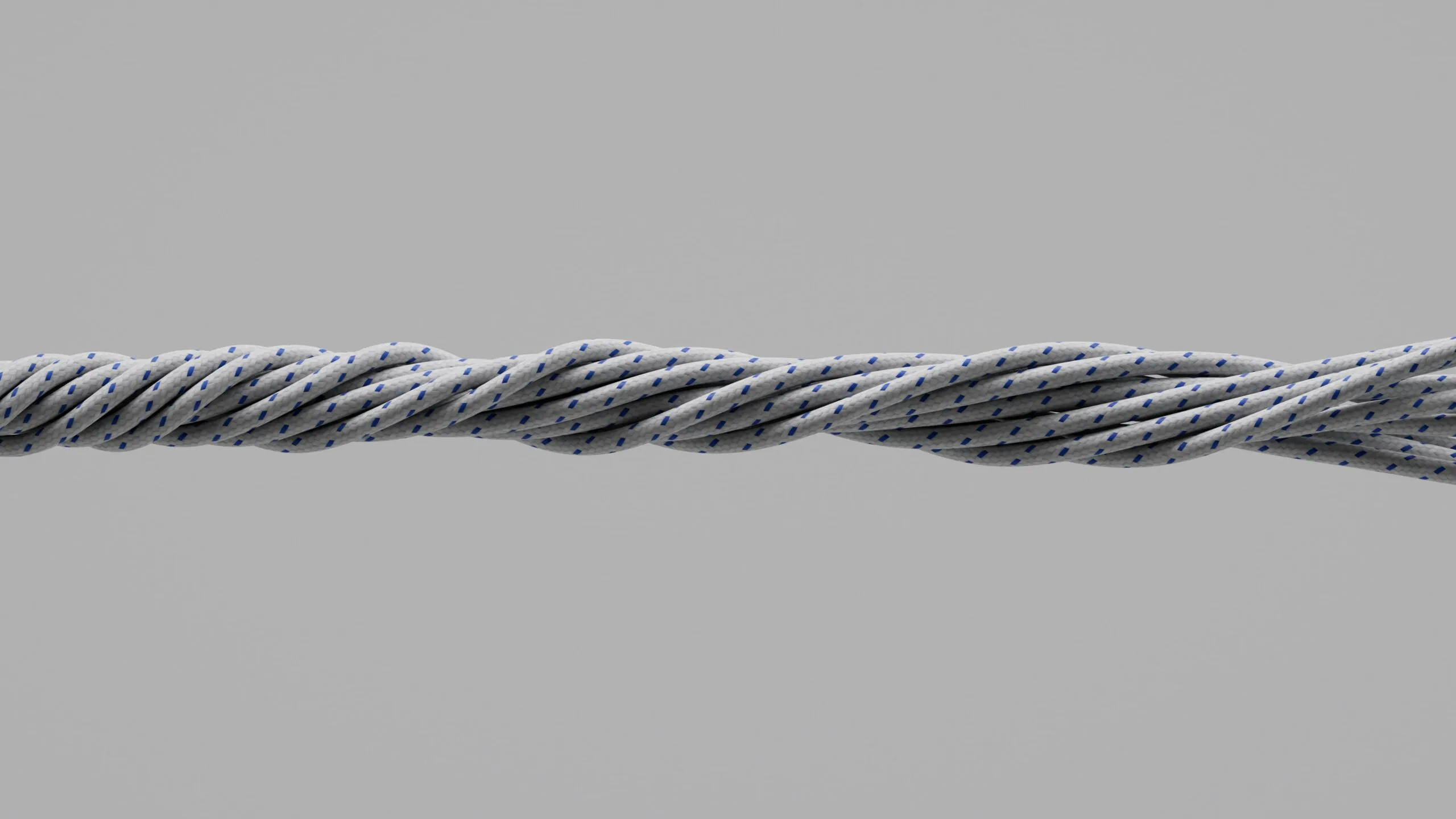 Close-up of twisted gray metal cable on gray background