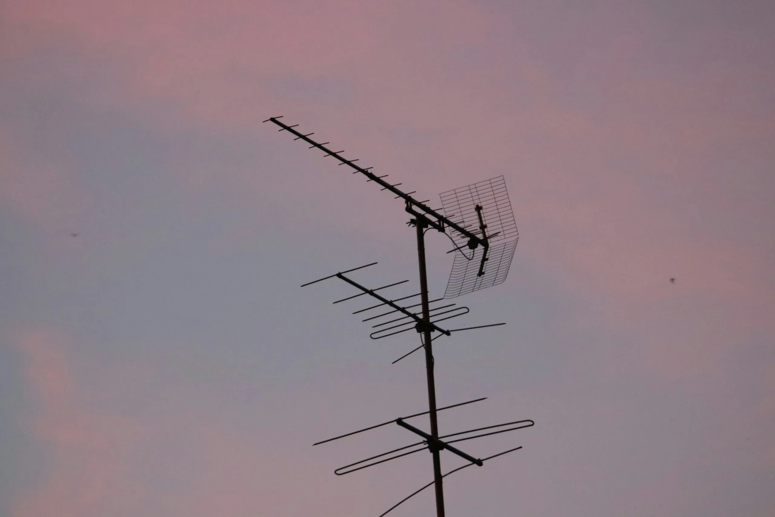a antenna with a pink sky