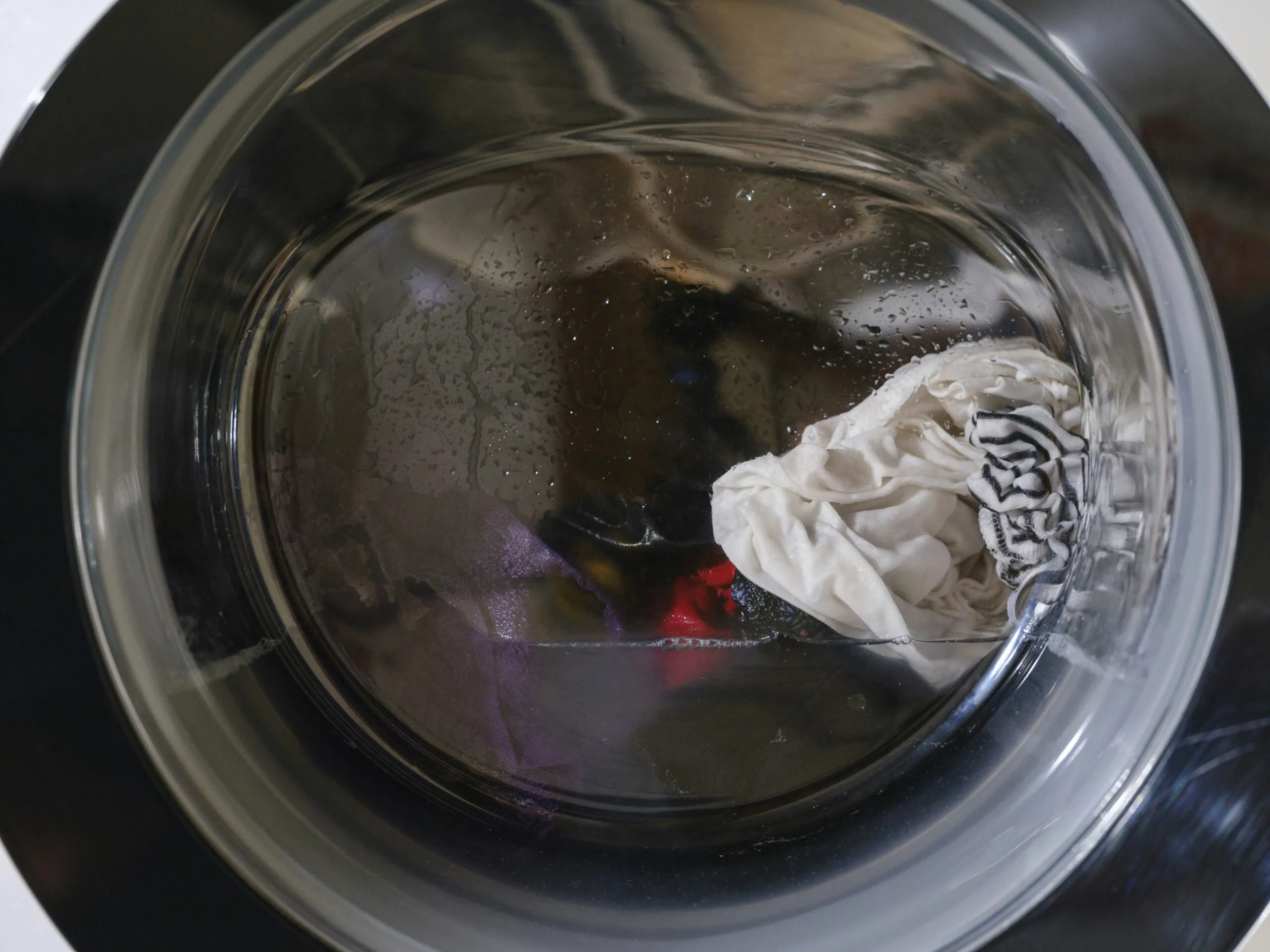 Washing machine drum with clothes and water
