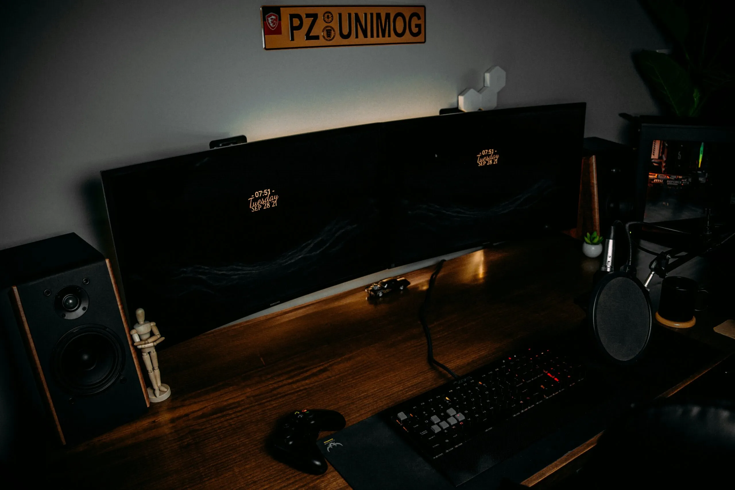 a computer desk with a keyboard and speakers
