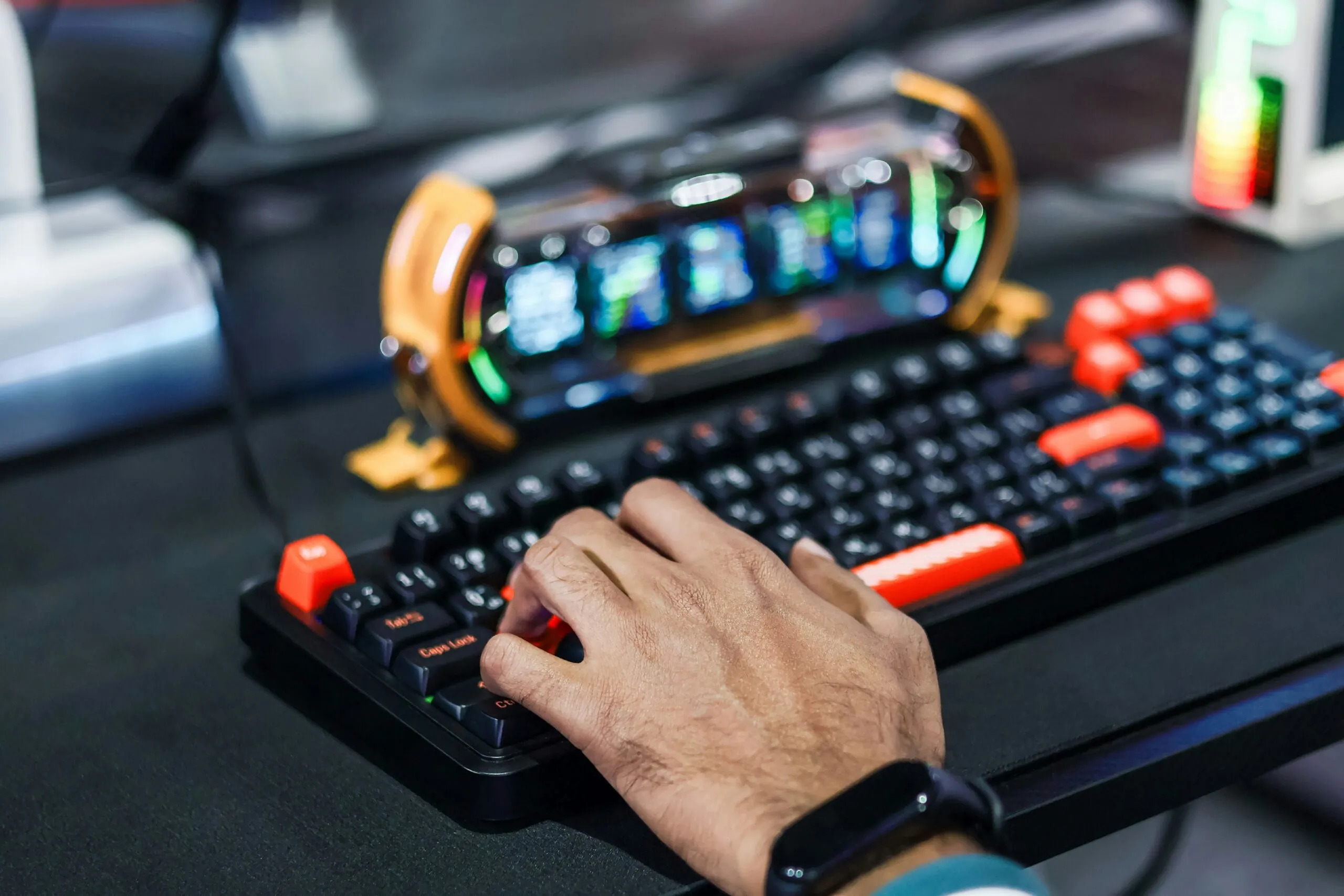 Person's hand typing on a gaming keyboard