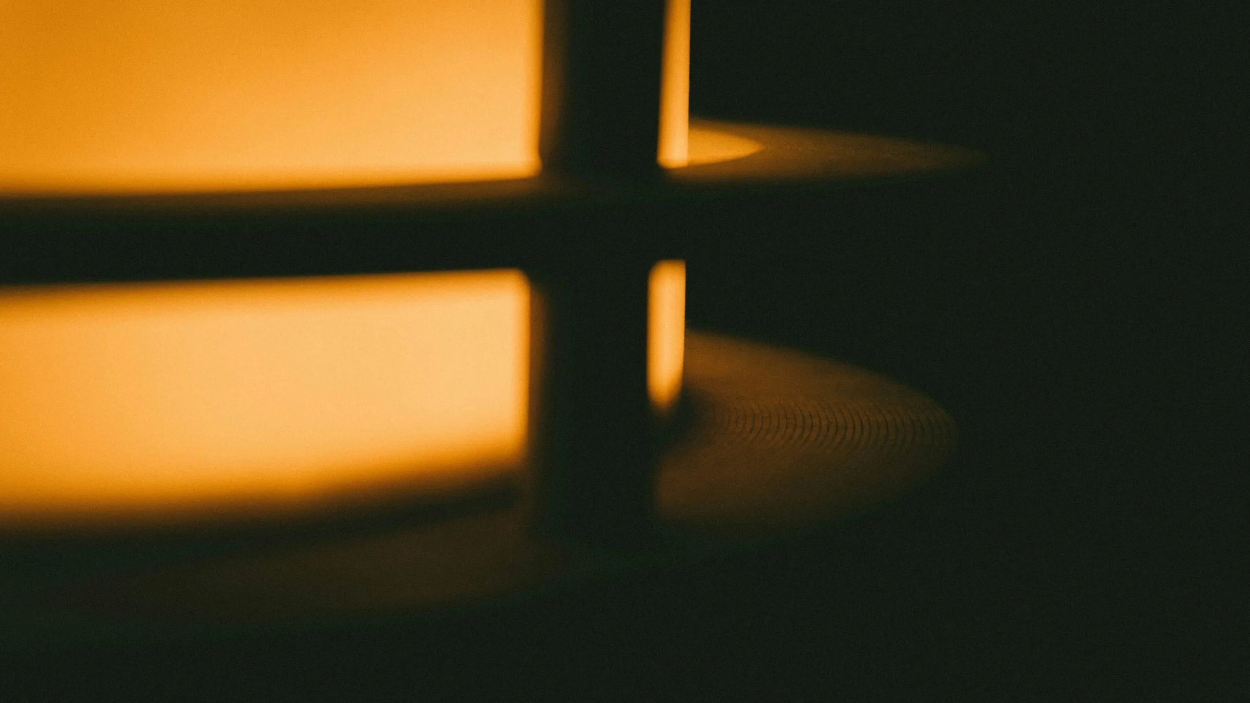 a close up of a light fixture in a dark room