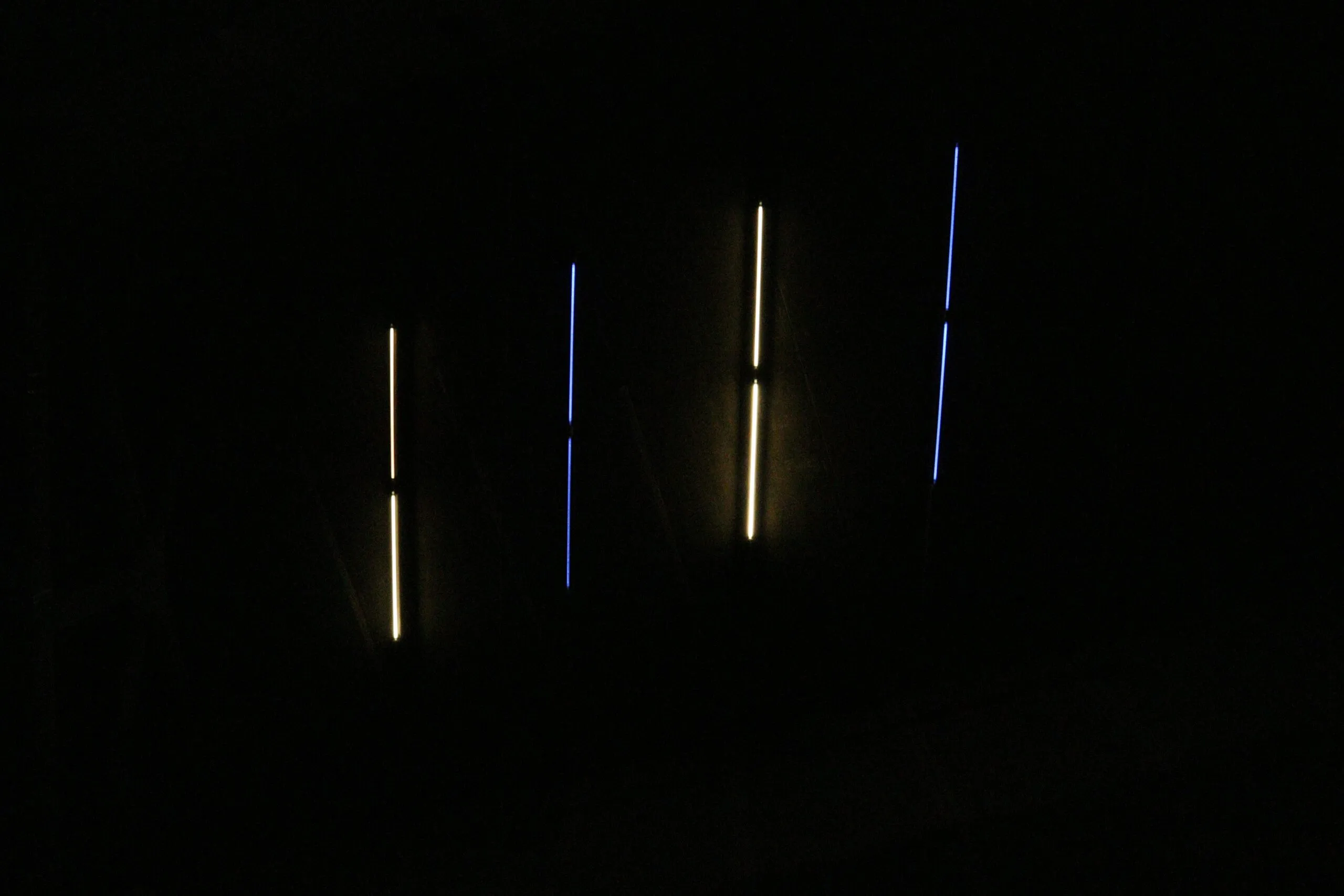 a dark room with three lights in the dark