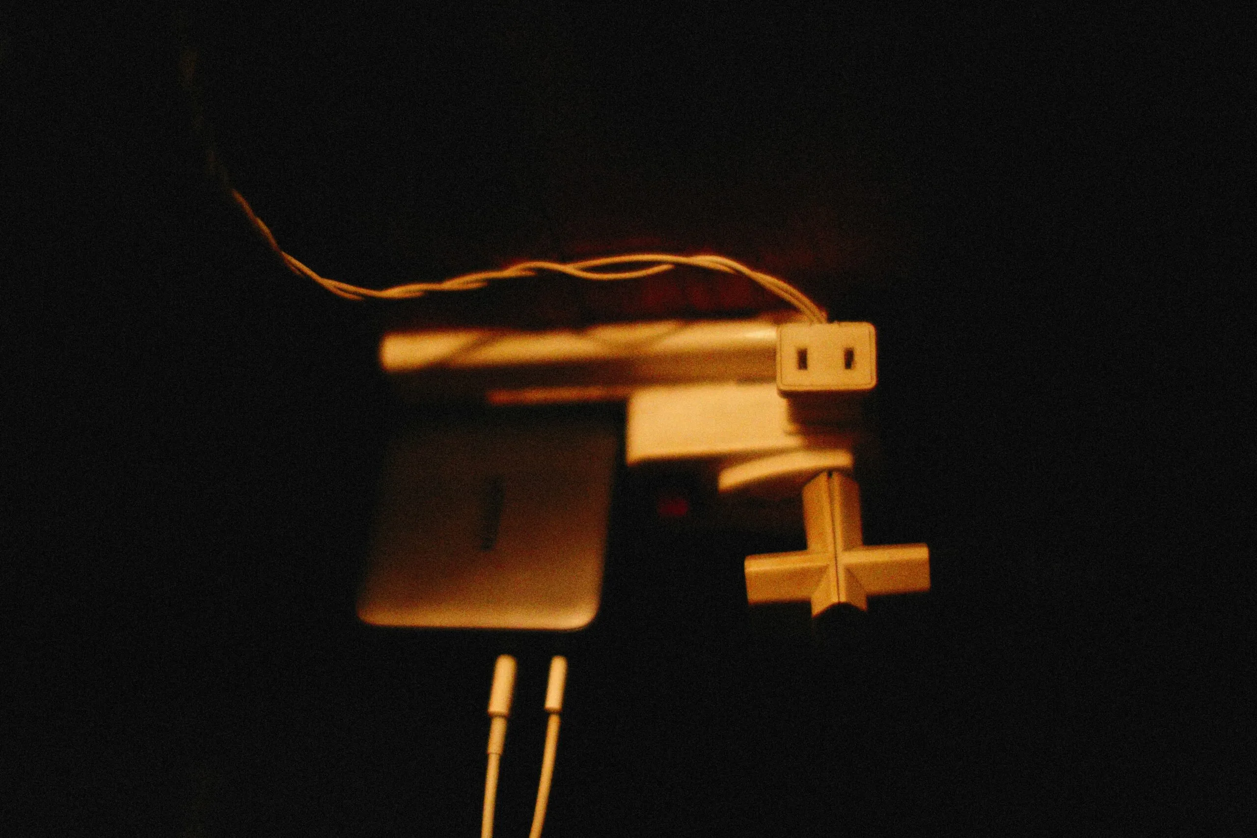 a computer mouse connected to a laptop in the dark