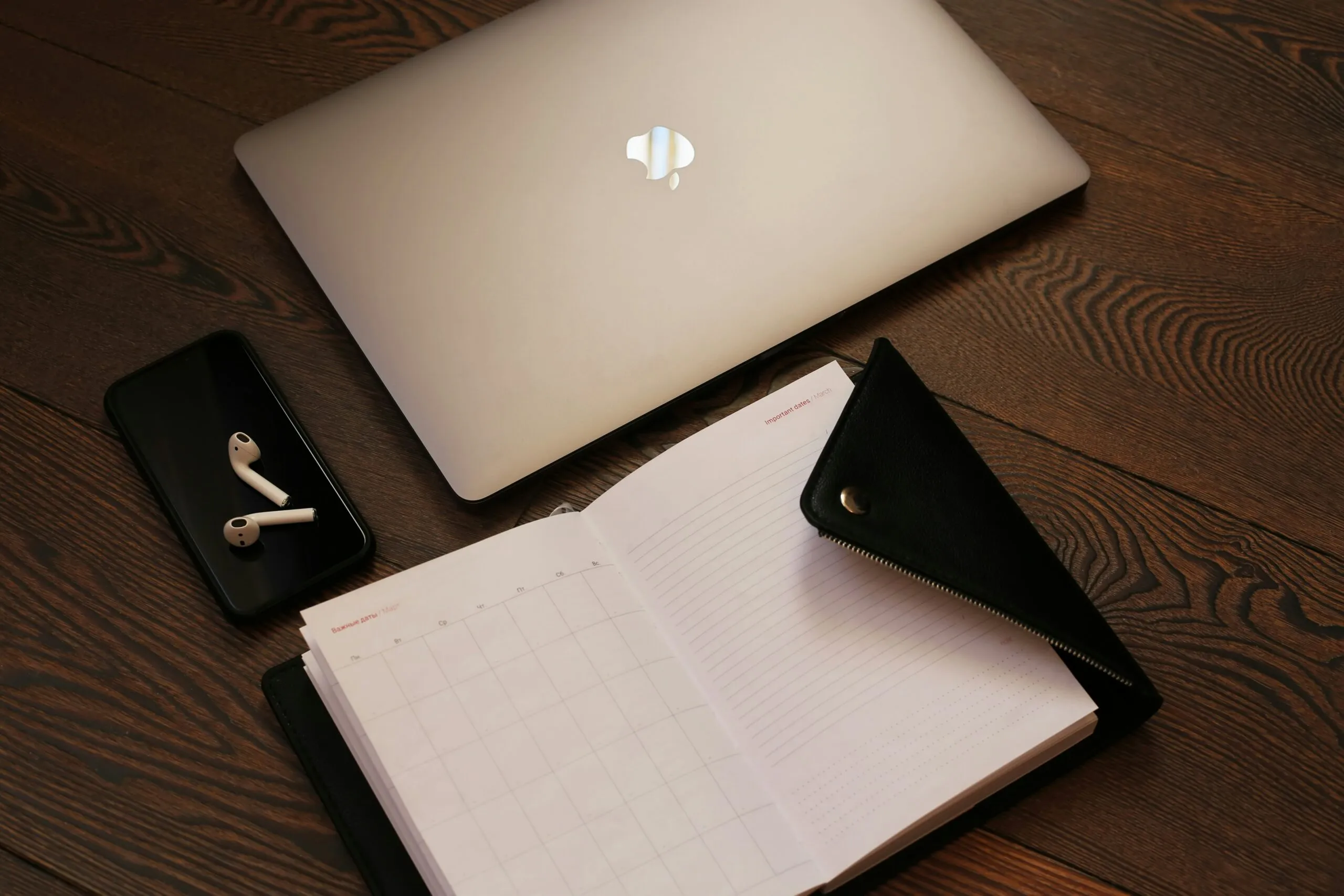 silver macbook beside black iphone 5