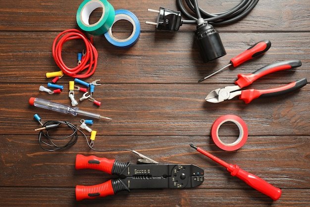 Different electrical tools on wooden background