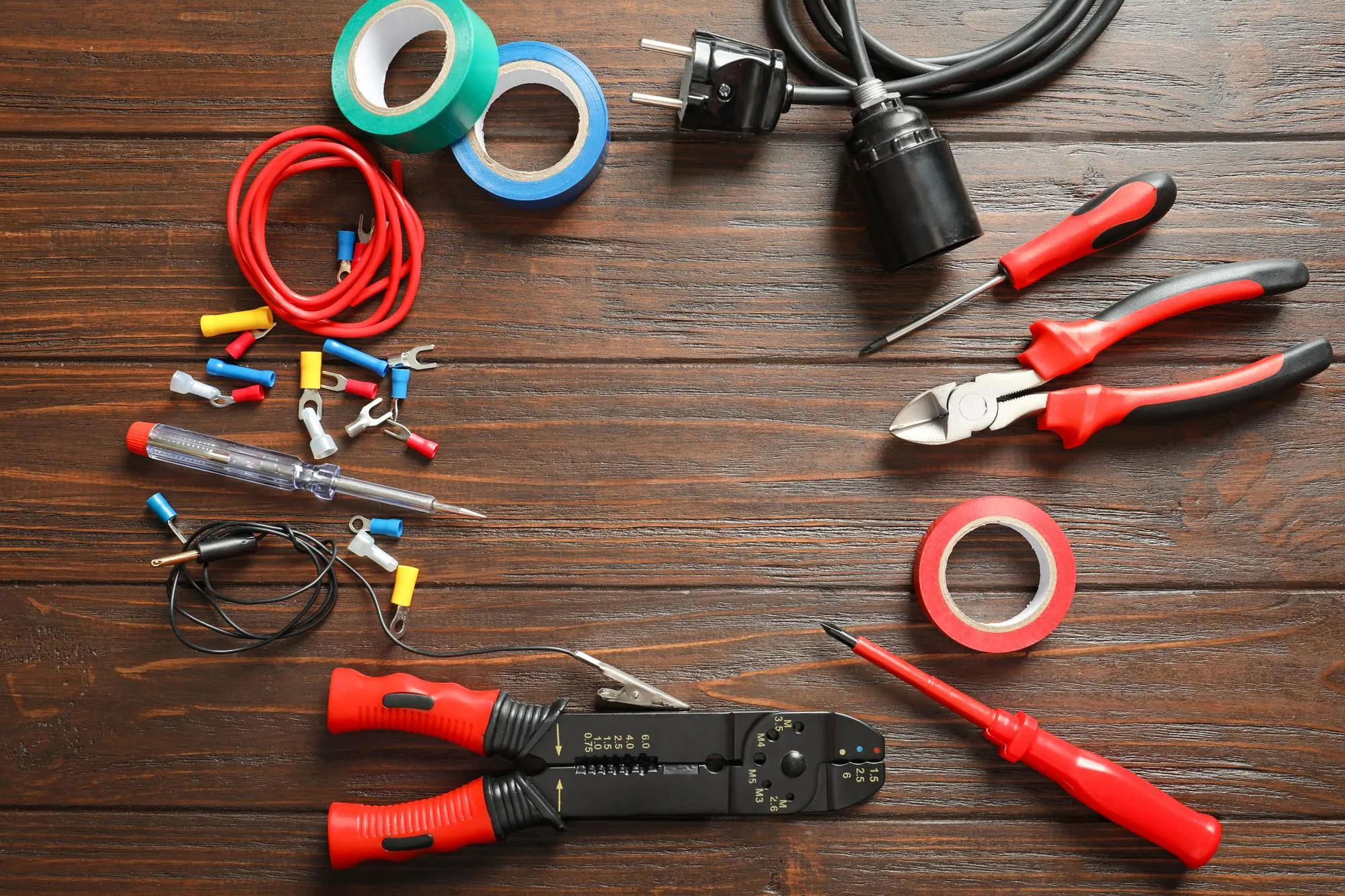 Different electrical tools on wooden background