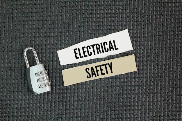 Lock and paper with the word Electrical safety the practices and measures taken to prevent injuries