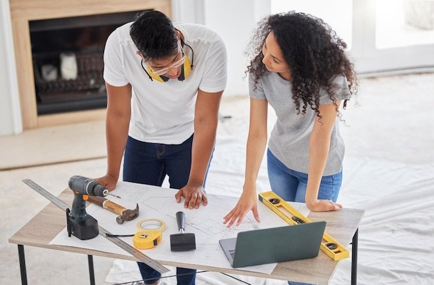 Maintenance renovation and diy planning with a couple in their new home together for a remodeling project Construction real estate or property blueprint with a man and woman talking in the house