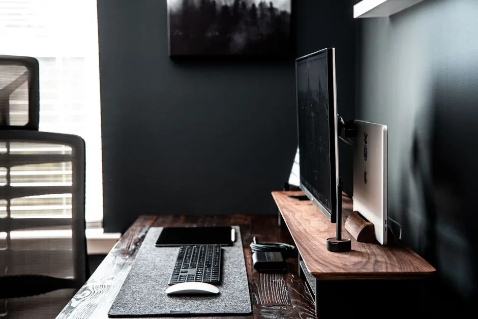 Modern equipment for remote work including computer with wireless keyboard and mouse with tablet arranged on wooden table