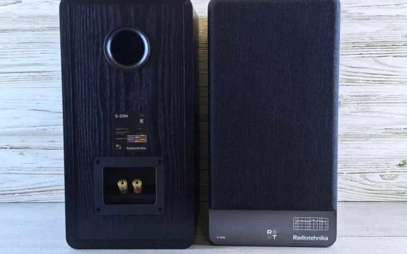 Radiotehnika S-20N stereo speakers in vintage design on a wooden background, showcasing retro audio equipment.