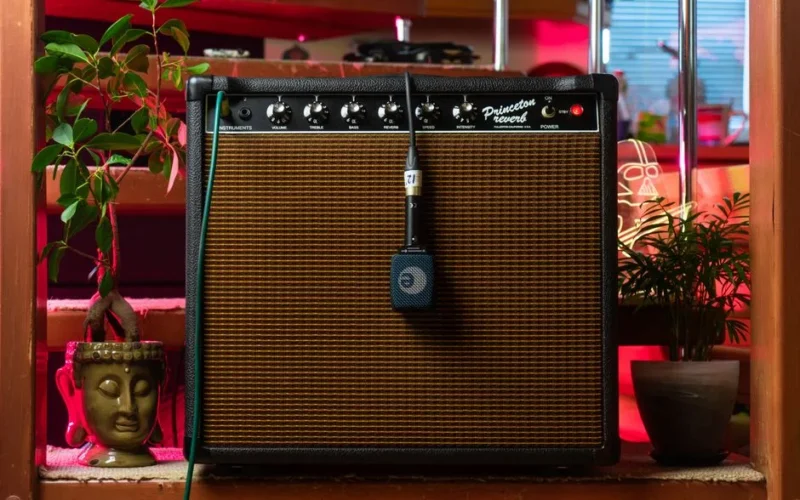 A retro combo amplifier with a microphone in a cozy indoor setting.