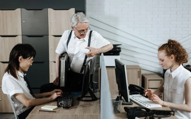 Group of diverse office workers collaborating at their desks. Professional teamwork setting.