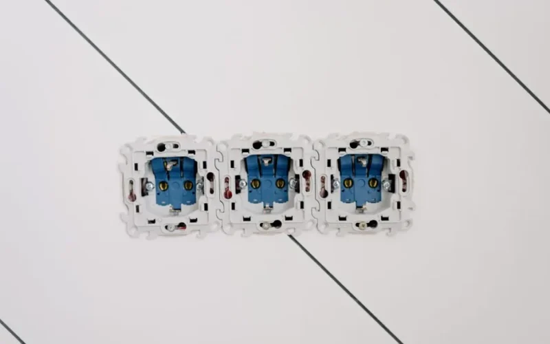 Power sockets with various connectors and bolts on wall in room at home