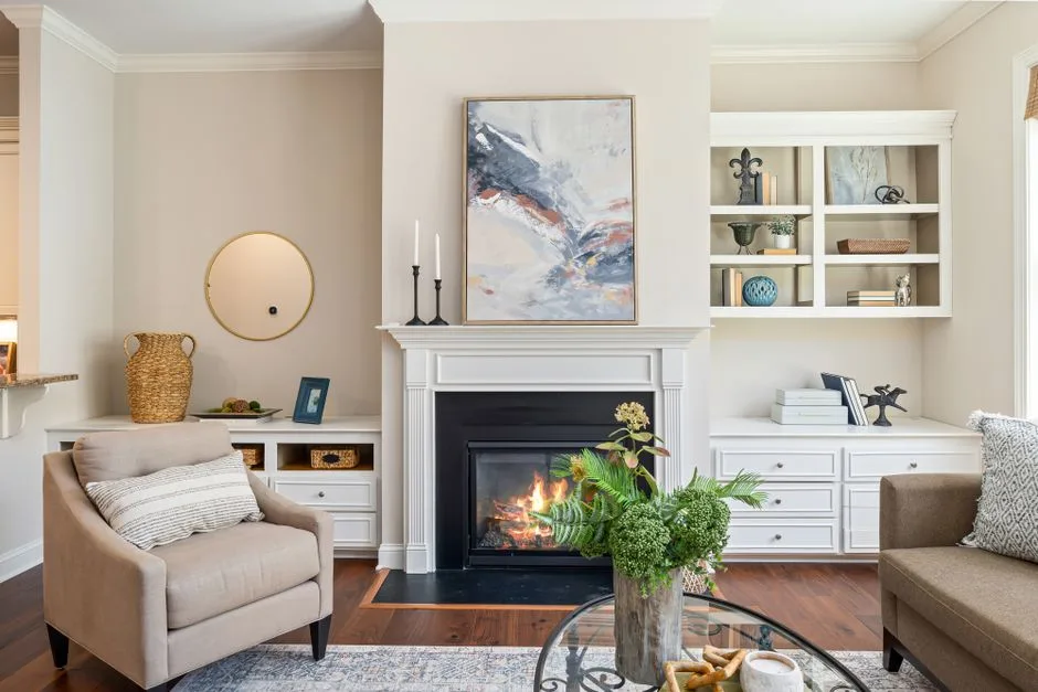 Elegant living room featuring a modern fireplace, art, and stylish furniture for a cozy ambiance.