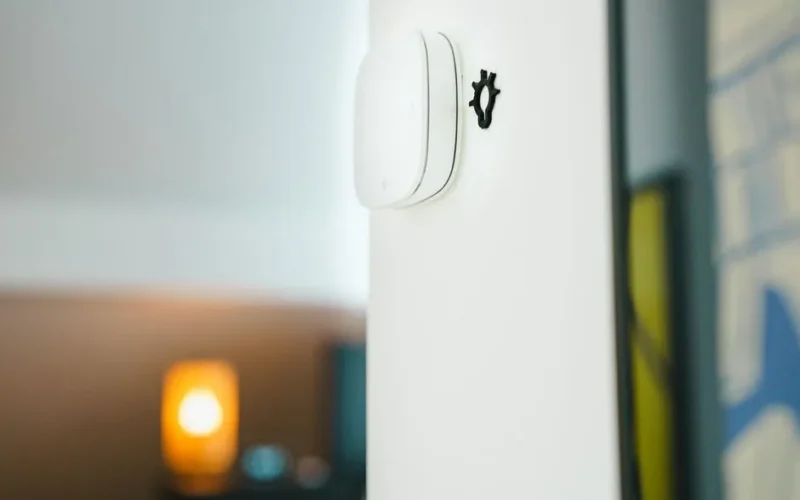 A sleek smart home light switch installed on a wall, showcasing modern technology in living spaces.