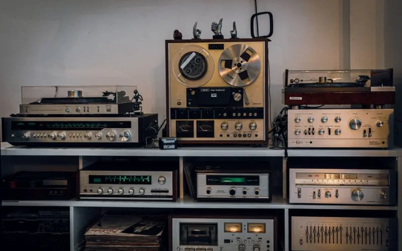 A collection of vintage audio equipment including reel-to-reel, turntables, and amplifiers.