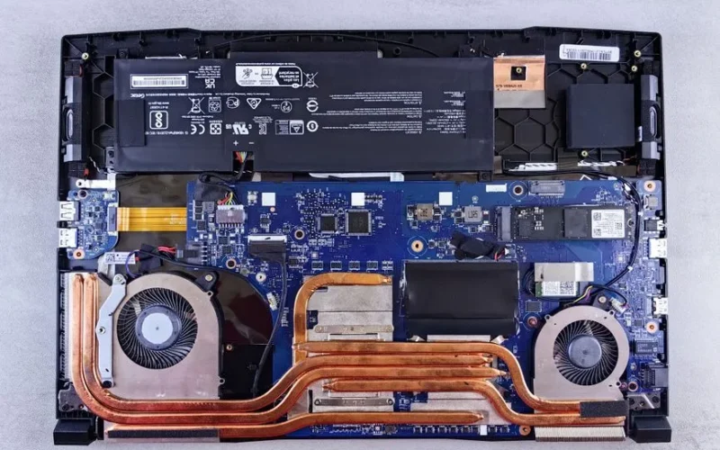 Detailed view of laptop motherboard and cooling system components.