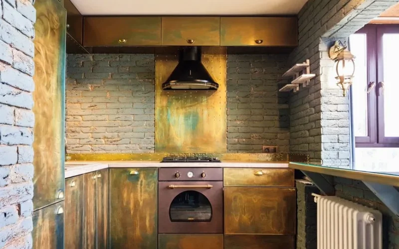 Cozy rustic kitchen with brass cabinets and modern appliances, exuding industrial charm.
