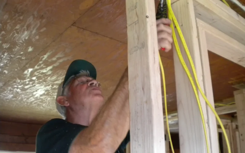 Tanana, AK, July 31, 2009 -- Christian Reformed World Relief Committee Volunteer, Joe Treffers, is doing electrical work in a flood damaged home in Tanana, AK. - Ben Brennan/FEMA