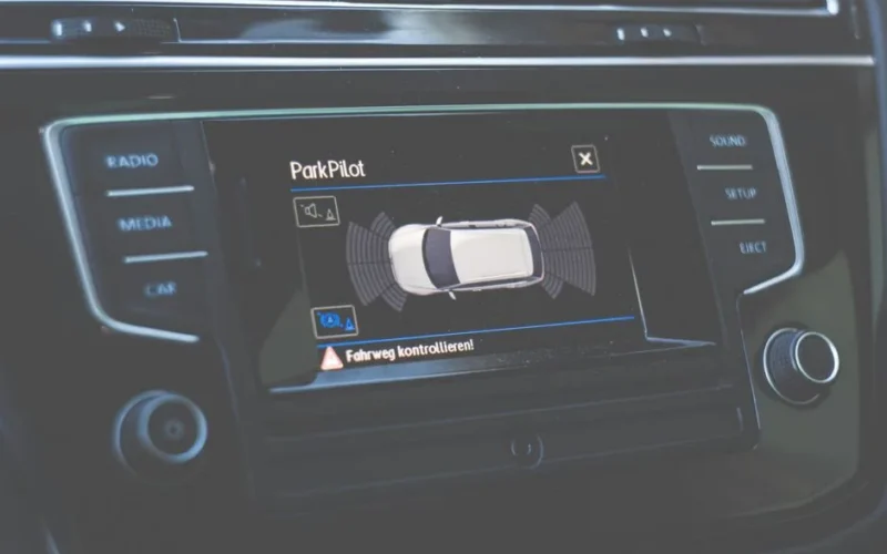 Close-up view of a car dashboard featuring a ParkPilot parking assist display.